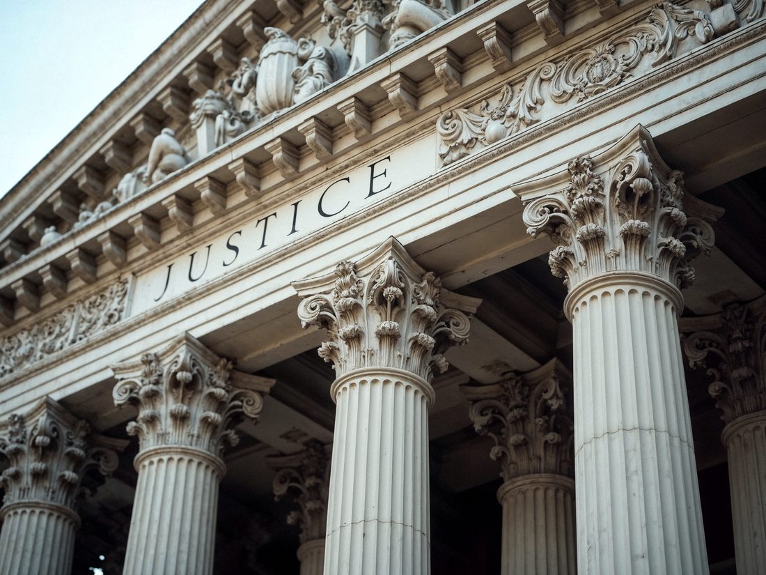 Courthouse facade bearing the word Justice
